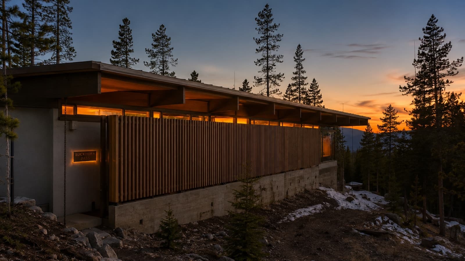 Buckhorn Pass — restored 1972 modernist residence at dusk with new cedar screen facade